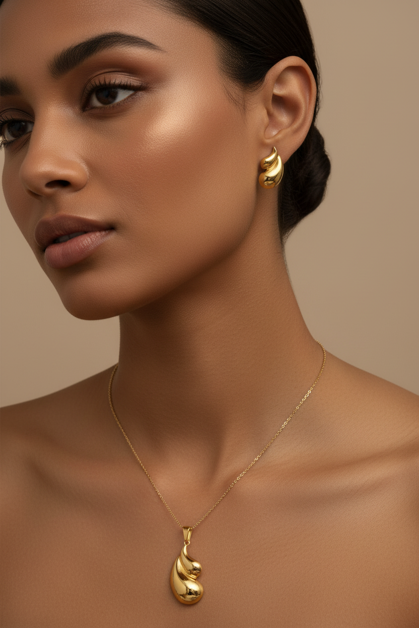 Model wearing the 18K Gold Plated Abstract Fluid Wave Pendant Necklace and Earring Set