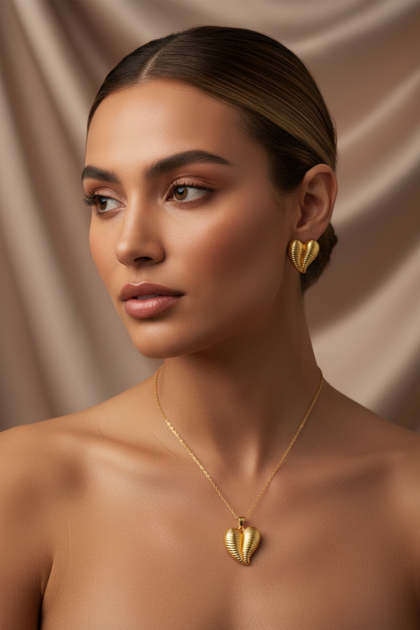 Model wearing the 18K Gold Plated Ribbed Winged Heart Pendant Necklace and Earring Set